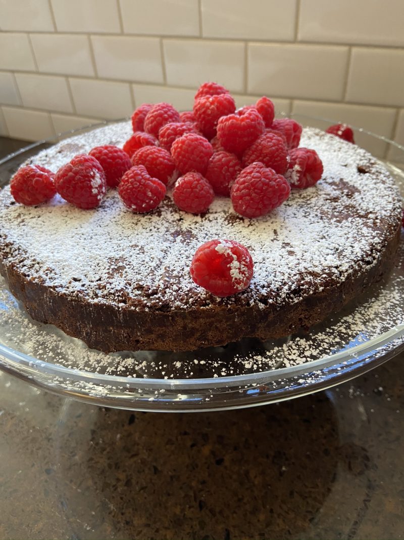 Cake decorated with raspberries and sugar