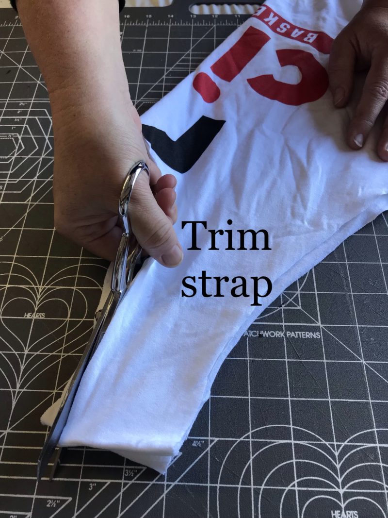 white t-shirt with instructions to trim for strap