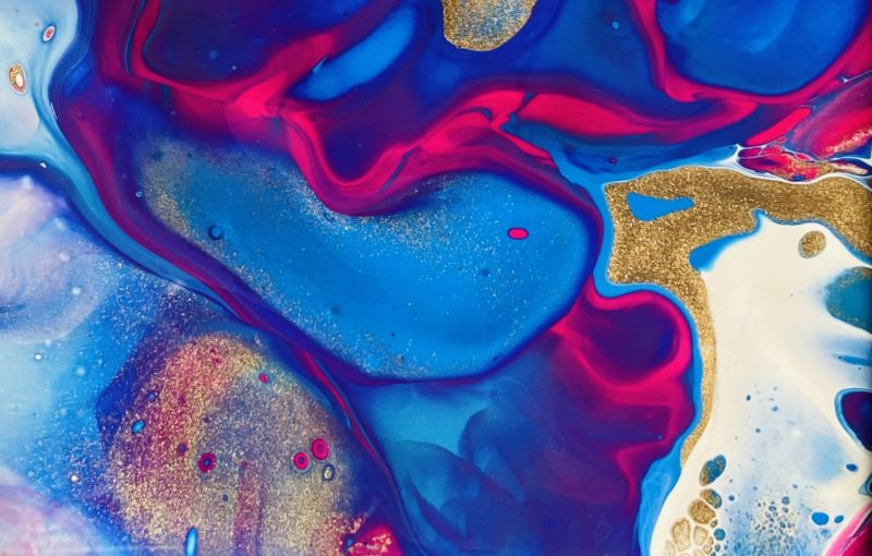blue, pink, gold, white paint in swriled dutch paint pour pattern