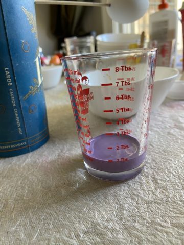 1 tbs of purple paint in a cup